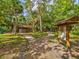 Park pathway leading to a unique stone restroom and information kiosk nestled in a serene environment at 803 Helmsman Way, Palm Harbor, FL 34685