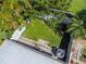 Aerial view of a private backyard with lush greenery, mature trees, and a white fence, creating a serene outdoor space at 914 Woodbridge Ct, Safety Harbor, FL 34695