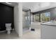 Modern bathroom with a glass-enclosed shower, soaking tub, and dual sink vanity at 914 Woodbridge Ct, Safety Harbor, FL 34695