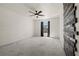 Large bedroom with a ceiling fan, carpeted floors, and decorative wooden wall accent at 914 Woodbridge Ct, Safety Harbor, FL 34695
