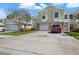 Well-maintained townhome with an attached garage and brick paver driveway at 914 Woodbridge Ct, Safety Harbor, FL 34695