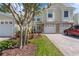 Charming townhome featuring a brick-accented facade, a paver driveway, and mature landscaping in the front yard at 914 Woodbridge Ct, Safety Harbor, FL 34695