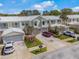 Beautiful townhomes featuring brick driveways, metal roofs, and attached garages at 914 Woodbridge Ct, Safety Harbor, FL 34695