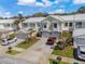 Townhomes with attached garages and brick driveways under a blue sky at 914 Woodbridge Ct, Safety Harbor, FL 34695
