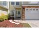 Charming townhome entrance featuring manicured landscaping and a well-lit entryway at 914 Woodbridge Ct, Safety Harbor, FL 34695