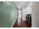Hallway with hardwood floors, leading to rooms, and featuring a laundry area with front loading washer and dryer at 914 Woodbridge Ct, Safety Harbor, FL 34695