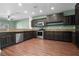 Modern kitchen with stainless steel appliances, granite countertops, and dark wood cabinets at 914 Woodbridge Ct, Safety Harbor, FL 34695