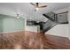 Open concept living room with kitchen, breakfast bar, staircase, and wood-look floors at 914 Woodbridge Ct, Safety Harbor, FL 34695