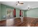 Living room with wood-look floors and sliding doors to the covered patio at 914 Woodbridge Ct, Safety Harbor, FL 34695
