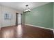 Bright living room with wood-look tile flooring, fresh paint, and modern light fixture at 914 Woodbridge Ct, Safety Harbor, FL 34695