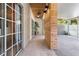 Covered patio with wood ceiling detail and access to both the house and screened in lanai at 914 Woodbridge Ct, Safety Harbor, FL 34695