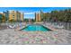 Community pool with lounge chairs and umbrellas offers a relaxing oasis for residents at 960 Starkey Rd # 5406, Largo, FL 33771