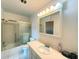 Bright bathroom with vanity, sink, medicine cabinet, shower, and toilet at 100 Bluff View Dr # 417A, Belleair Bluffs, FL 33770