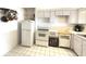 Well-lit kitchen featuring white cabinetry, essential appliances, and functional layout at 100 Bluff View Dr # 417A, Belleair Bluffs, FL 33770