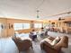 Spacious living room featuring wicker furniture, neutral paint, and natural light from the large windows at 100 Bluff View Dr # 417A, Belleair Bluffs, FL 33770