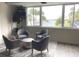 Comfortable lounge area with stylish seating and a view of palm trees and the water at 100 Bluff View Dr # 417A, Belleair Bluffs, FL 33770