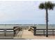Picturesque pier featuring scenic water views, benches, and a palm tree at 100 Bluff View Dr # 417A, Belleair Bluffs, FL 33770