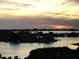 Breathtaking water view with an American flag, islands, and a sunset over the water at 100 Bluff View Dr # 417A, Belleair Bluffs, FL 33770