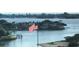 Picturesque waterfront view highlighting an American flag, surrounding homes, and the intracoastal waterway at 100 Bluff View Dr # 417A, Belleair Bluffs, FL 33770