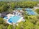 Aerial view of the community pool and tennis courts surrounded by lush greenery at 10561 Greencrest Dr, Tampa, FL 33626
