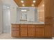 Bathroom vanity with granite counters, wood cabinets, and neutral tile flooring at 10561 Greencrest Dr, Tampa, FL 33626