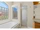 Bathroom with soaking tub under a window and separate shower in the corner at 10561 Greencrest Dr, Tampa, FL 33626