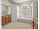 Light and bright bathroom with soaking tub under a window and granite countertops at 10561 Greencrest Dr, Tampa, FL 33626