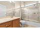 Bathroom featuring a single sink vanity and a shower-tub combination with glass sliding doors at 10561 Greencrest Dr, Tampa, FL 33626