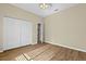 A carpetless bedroom with a closet and an open door showcases the neutral color palette and simple design at 10561 Greencrest Dr, Tampa, FL 33626