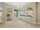 Bright dining area boasts pool views through large windows and an elegant chandelier at 10561 Greencrest Dr, Tampa, FL 33626