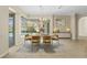 Bright dining room with a view of the pool, stylish lighting, and a modern table setting at 10561 Greencrest Dr, Tampa, FL 33626