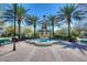 Beautiful fountain surrounded by palm trees and benches creating a relaxing community space at 10561 Greencrest Dr, Tampa, FL 33626