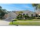 Charming home with a well-manicured lawn, mature landscaping, and a welcoming two-car garage at 10561 Greencrest Dr, Tampa, FL 33626