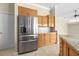 Kitchen featuring stainless steel appliances, wood cabinetry, and a tile backsplash at 10561 Greencrest Dr, Tampa, FL 33626