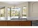 Kitchen island features a stainless steel sink, granite countertops and pool views at 10561 Greencrest Dr, Tampa, FL 33626
