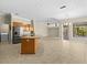 Open-concept kitchen with stainless steel appliances and a large island perfect for entertaining at 10561 Greencrest Dr, Tampa, FL 33626