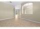 Open-concept living area with neutral paint, tile flooring, and an arched doorway at 10561 Greencrest Dr, Tampa, FL 33626