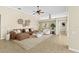 Spacious living room with a modern ceiling fan and stylish neutral-toned decor at 10561 Greencrest Dr, Tampa, FL 33626