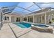 Beautiful pool with spa in screened enclosure and access to the main residence at 10561 Greencrest Dr, Tampa, FL 33626