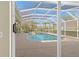Screened-in pool area with a jacuzzi and beautiful view of the lake at 10561 Greencrest Dr, Tampa, FL 33626
