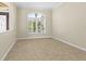 A light-filled room with tiled flooring, plantation shutters, and neutral paint at 10561 Greencrest Dr, Tampa, FL 33626
