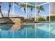 Water trickles from the spa's stone wall into the sparkling swimming pool at 10561 Greencrest Dr, Tampa, FL 33626