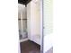 An open-air bathroom with tiled shower, toilet, and storage at 1208 E Kennedy Blvd # 1022, Tampa, FL 33602