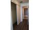 Hallway view includes closet, bathroom entrance, and complementary wood-style flooring at 1208 E Kennedy Blvd # 1022, Tampa, FL 33602