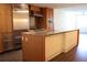 Modern kitchen featuring stainless steel appliances, spacious island, and wood cabinets at 1208 E Kennedy Blvd # 1022, Tampa, FL 33602