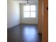 This living room features a ceiling fan, a large window, and hardwood floors at 1208 E Kennedy Blvd # 1022, Tampa, FL 33602