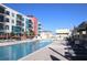 The large community pool is surrounded by residential buildings and pool furniture at 1208 E Kennedy Blvd # 1022, Tampa, FL 33602