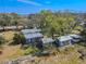 Aerial view showcasing the home's multiple structures, garden, and backyard at 12303 Greenland Dr, Riverview, FL 33579