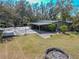 Aerial view of large backyard featuring a basketball court, patio, and verdant lawn at 12303 Greenland Dr, Riverview, FL 33579