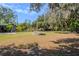 Spacious, treed backyard with firepit, ideal for outdoor gatherings and relaxation at 12303 Greenland Dr, Riverview, FL 33579